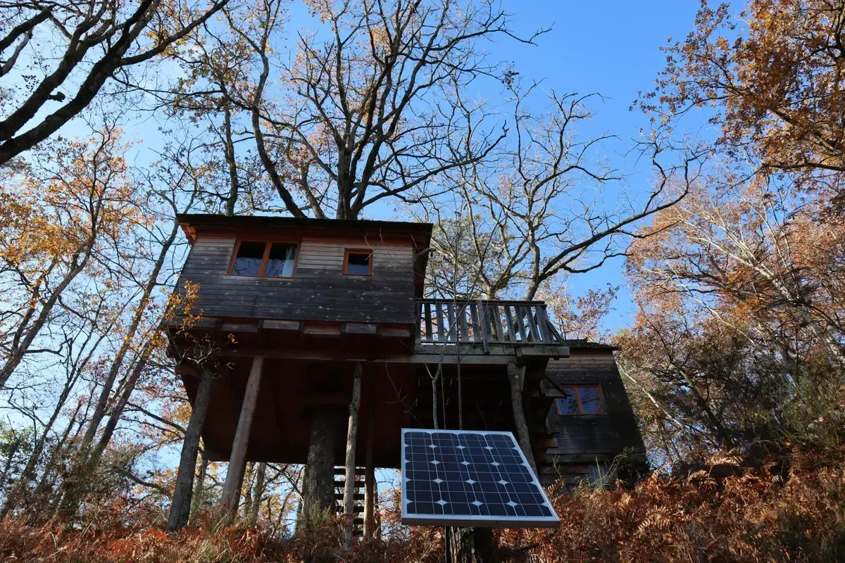 Solar panels and a power station set up at an off-grid cabin